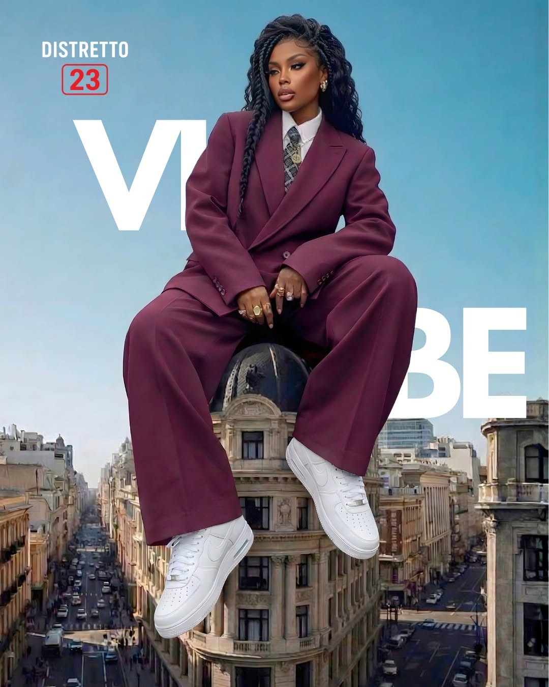 Donna in completo bordeaux e sneaker bianche seduta su una cupola sopra la città, scritta VIBE, logo Distretto 23